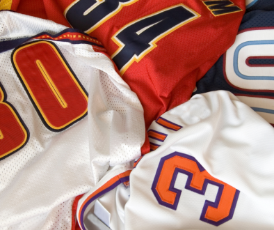 From Locker Room to Pro Shop_ The Evolution of Sports Merchandise - New Buffalo Shirt Factory Blog Featured IMG